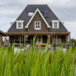 brown house behind green grass